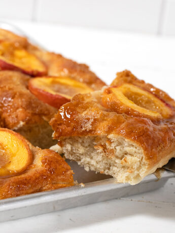Baltimore peach cake sliced on sheet pan