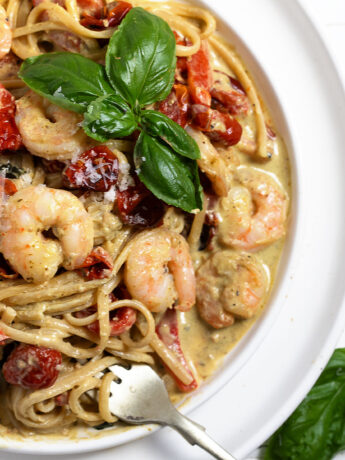 Creamy pesto shrimp pasta plated.