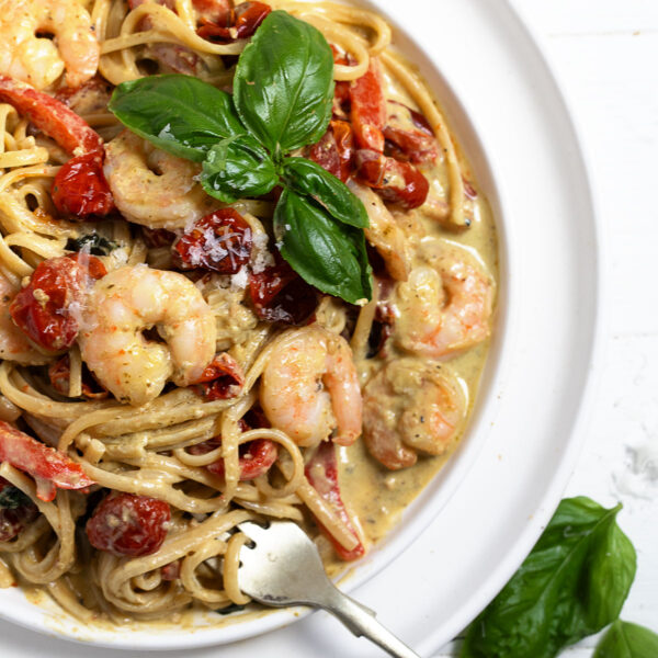 Creamy pesto shrimp pasta plated.