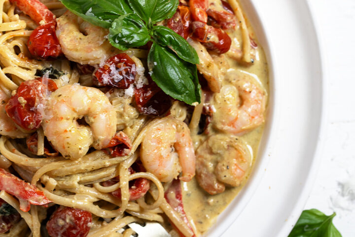 Creamy pesto shrimp pasta plated.
