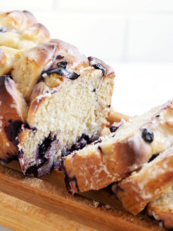 blueberry fritter bread sliced on cutting rack