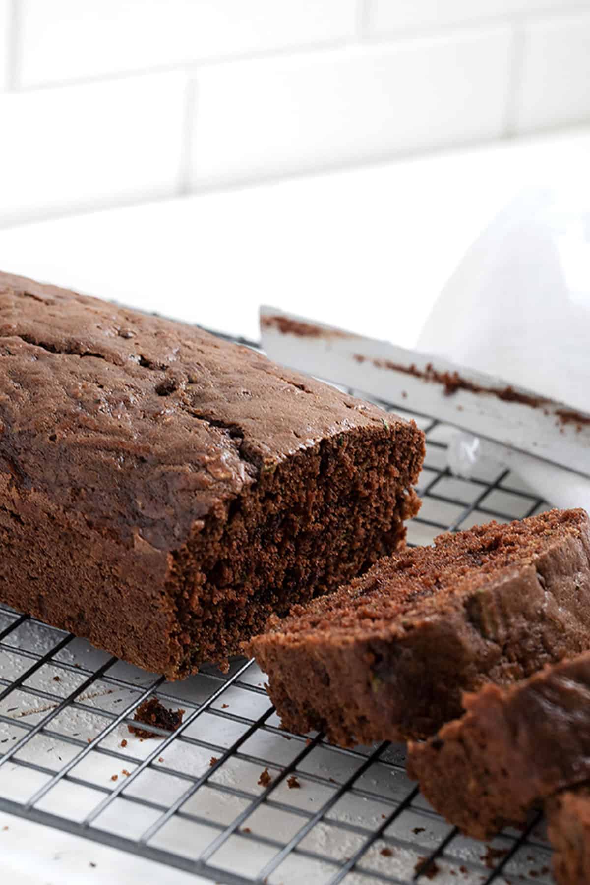 chocolate zucchini loaf sliced on cooling rack