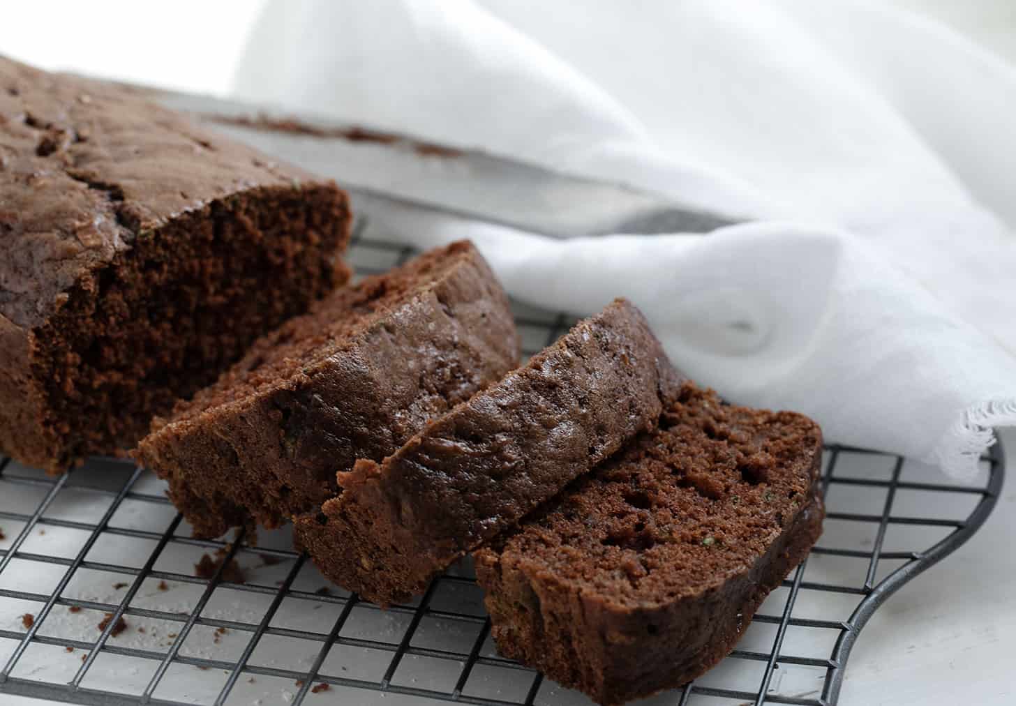 chocolate zucchini bread sliced on cooling rack
