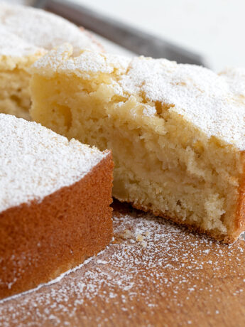 Italian apple cake sliced on cutting board