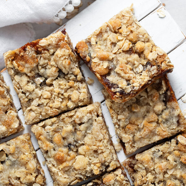 Old-fashioned date squares cut on serving board.