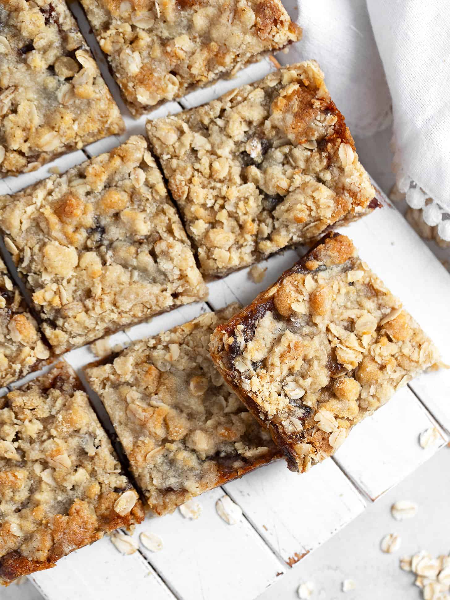 Old-fashioned date squares cut on serving board.