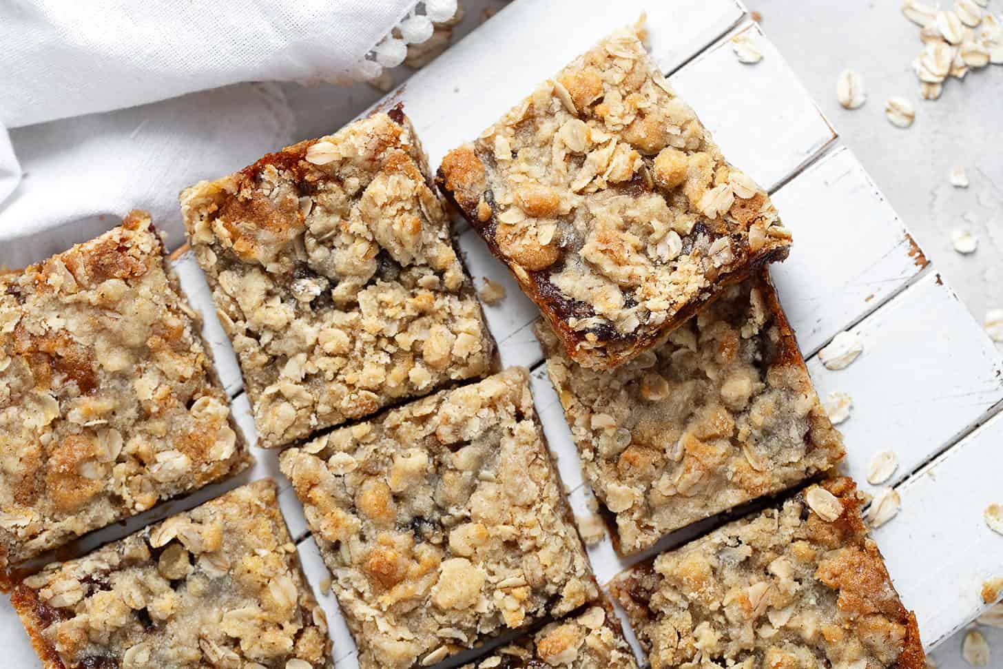 Old-fashioned date squares cut on serving board.