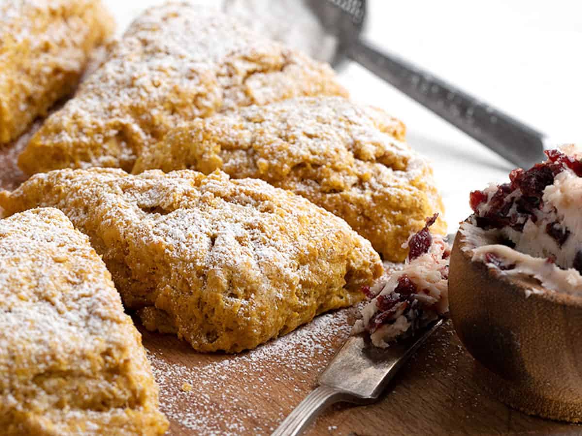 pumpkin scones on cutting board with cranberry butter