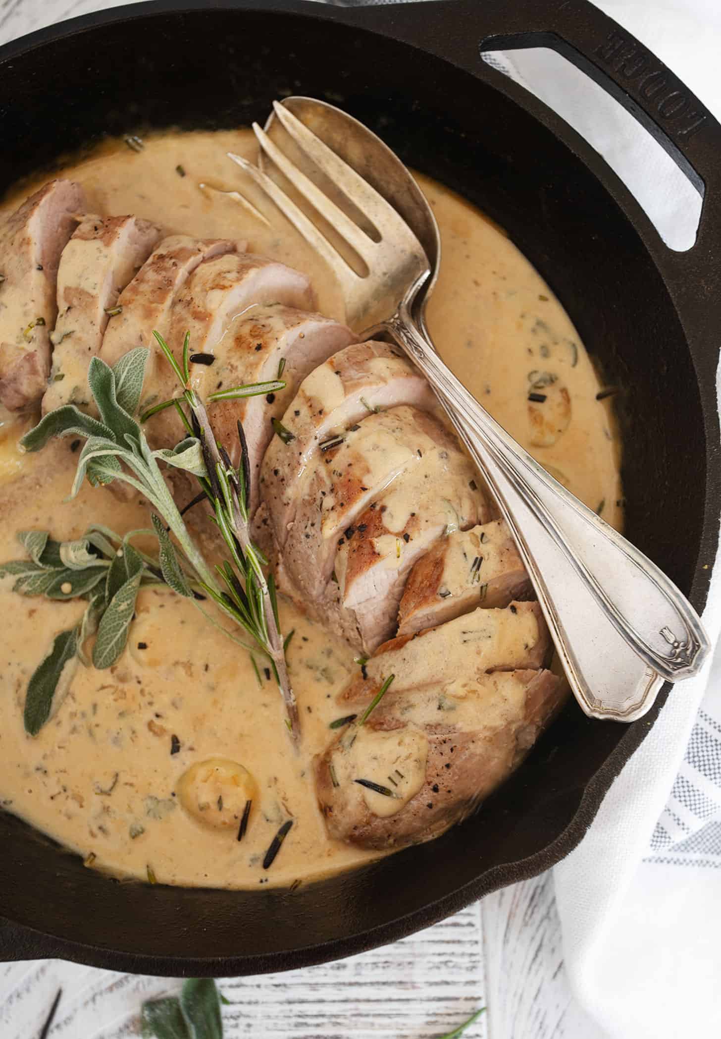 pork tenderloin with garlic herb gravy in cast iron skillet