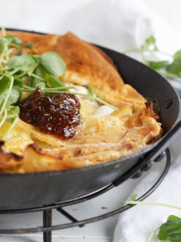 apple camembert Dutch baby in skillet with fig jam