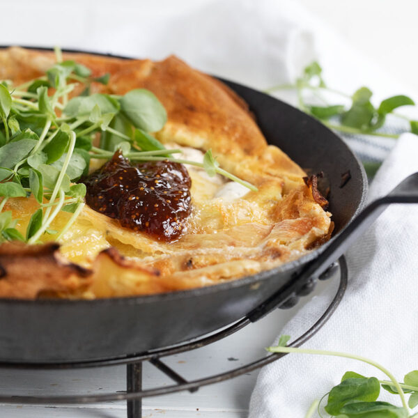 apple camembert Dutch baby in skillet with fig jam