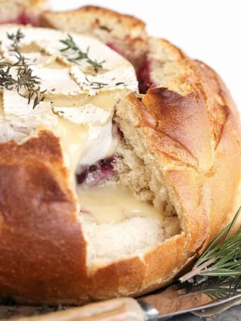 camembert cheese in bread round with cranberry sauce