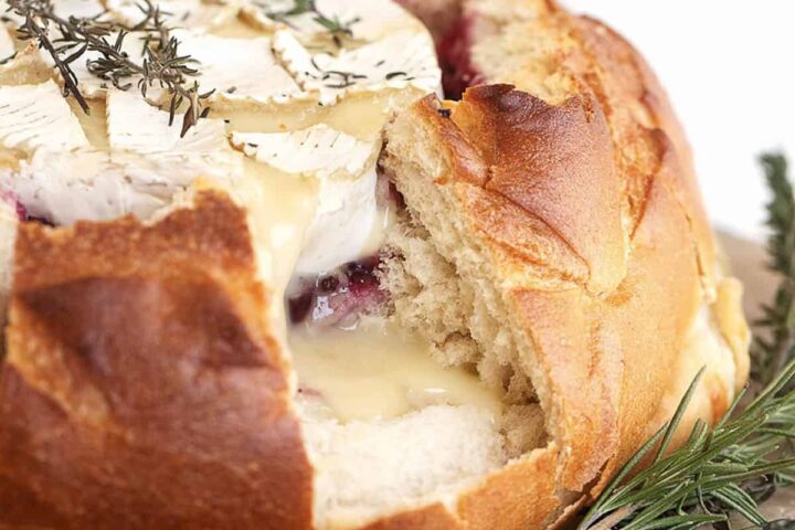 camembert cheese in bread round with cranberry sauce