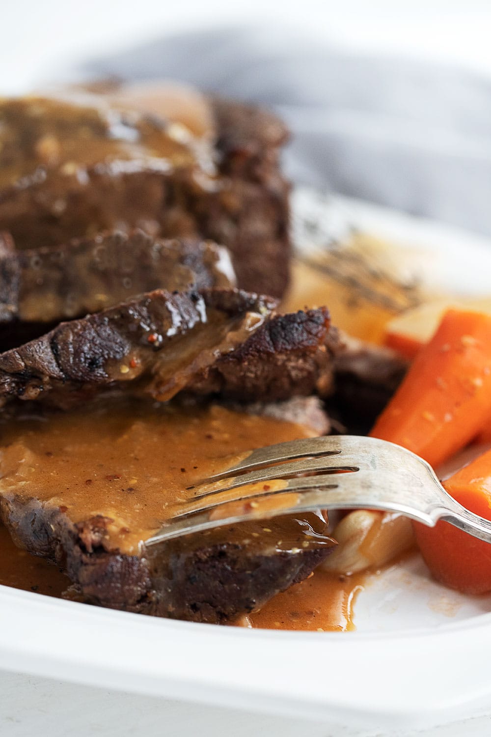 pot roast sliced with gravy, carrots and onions