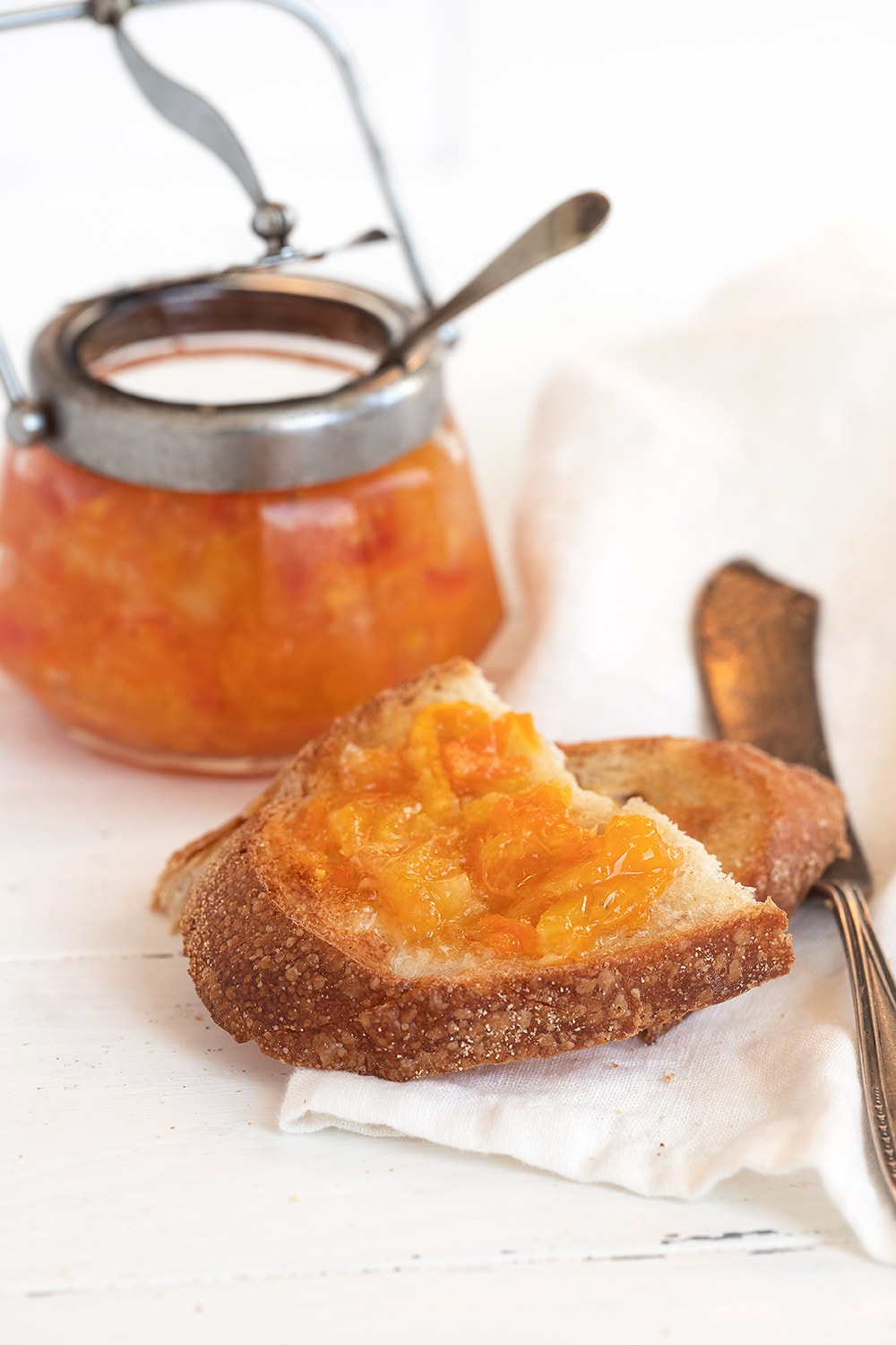 orange marmalade in jar and spread on toast