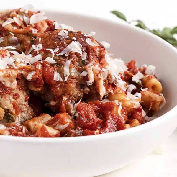 baked pork meatballs and pasta in white bowl