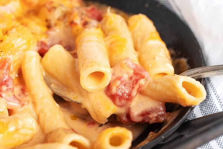 pasta and cheese with tomatoes in small cast iron pan