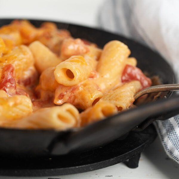 pasta with cheese and tomatoes in small skillet