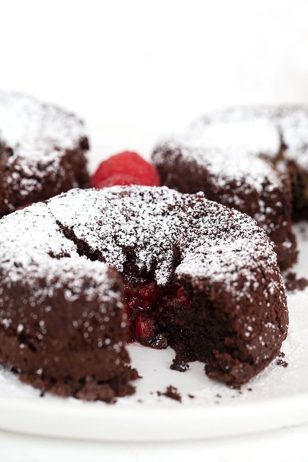 chocolate molten cakes with raspberry filling on plate with fork