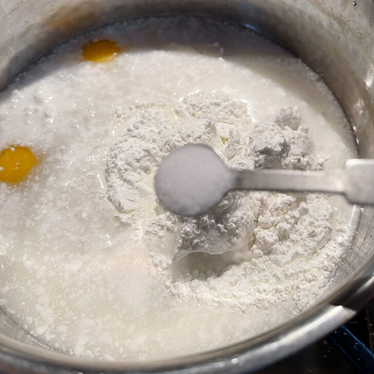 Adding the flour and salt to the saucepan.