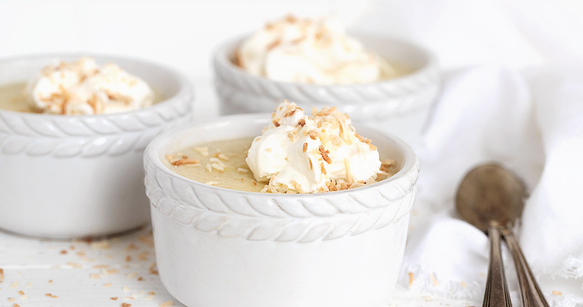 coconut cream pudding in white ramekins with spoons