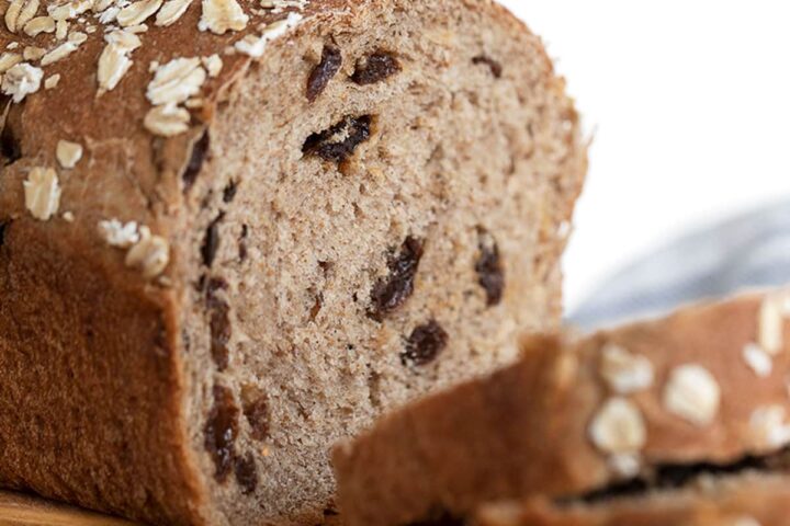 cinnamon raisin oatmeal bread on cutting board sliced