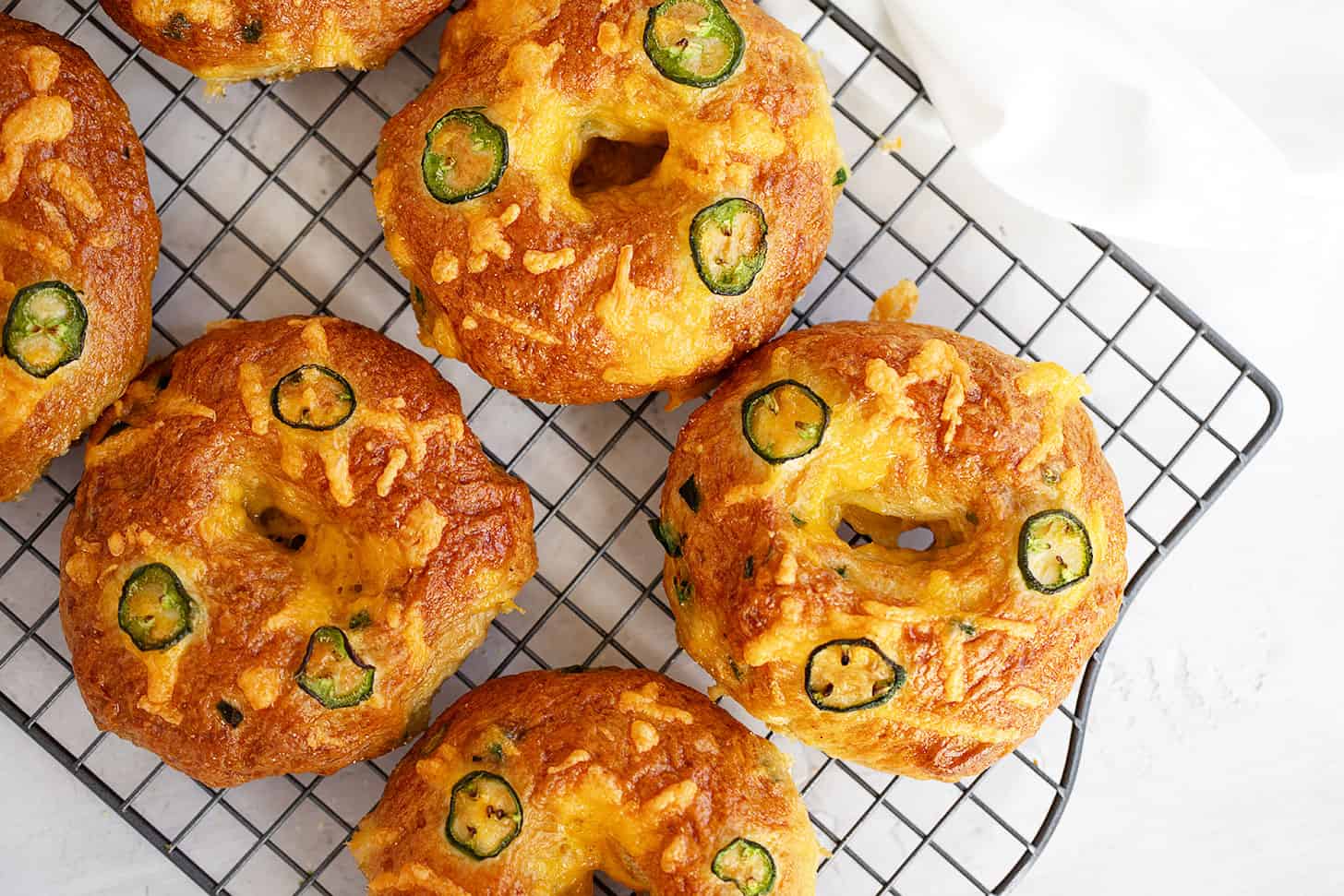 jalapeno cheddar bagels on wire rack