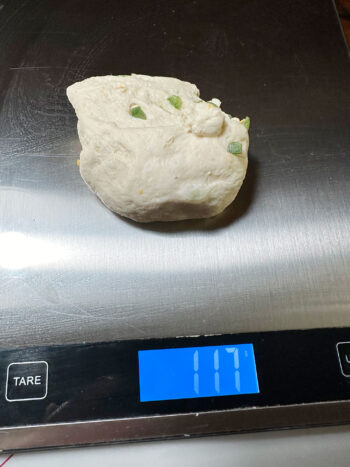 dough pieces being weighed on scale