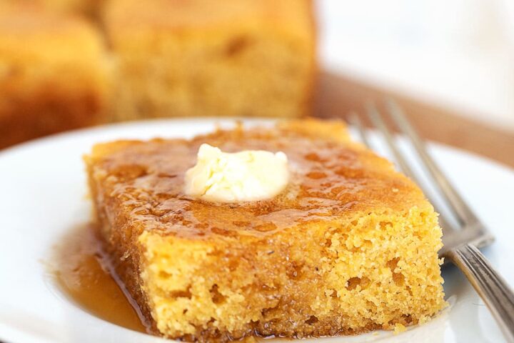 johnny cake with maple syrup and butter on plate