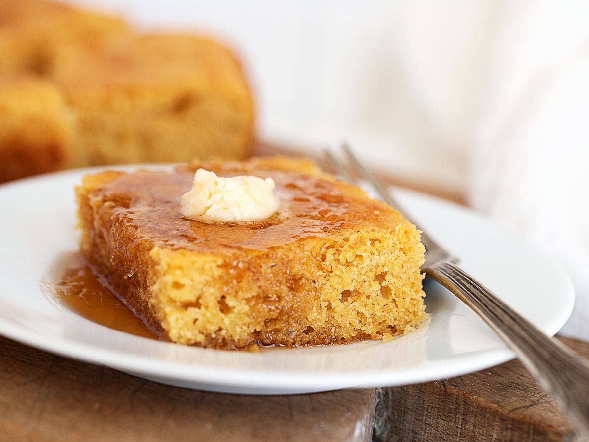 johnny cake with maple syrup and butter on plate