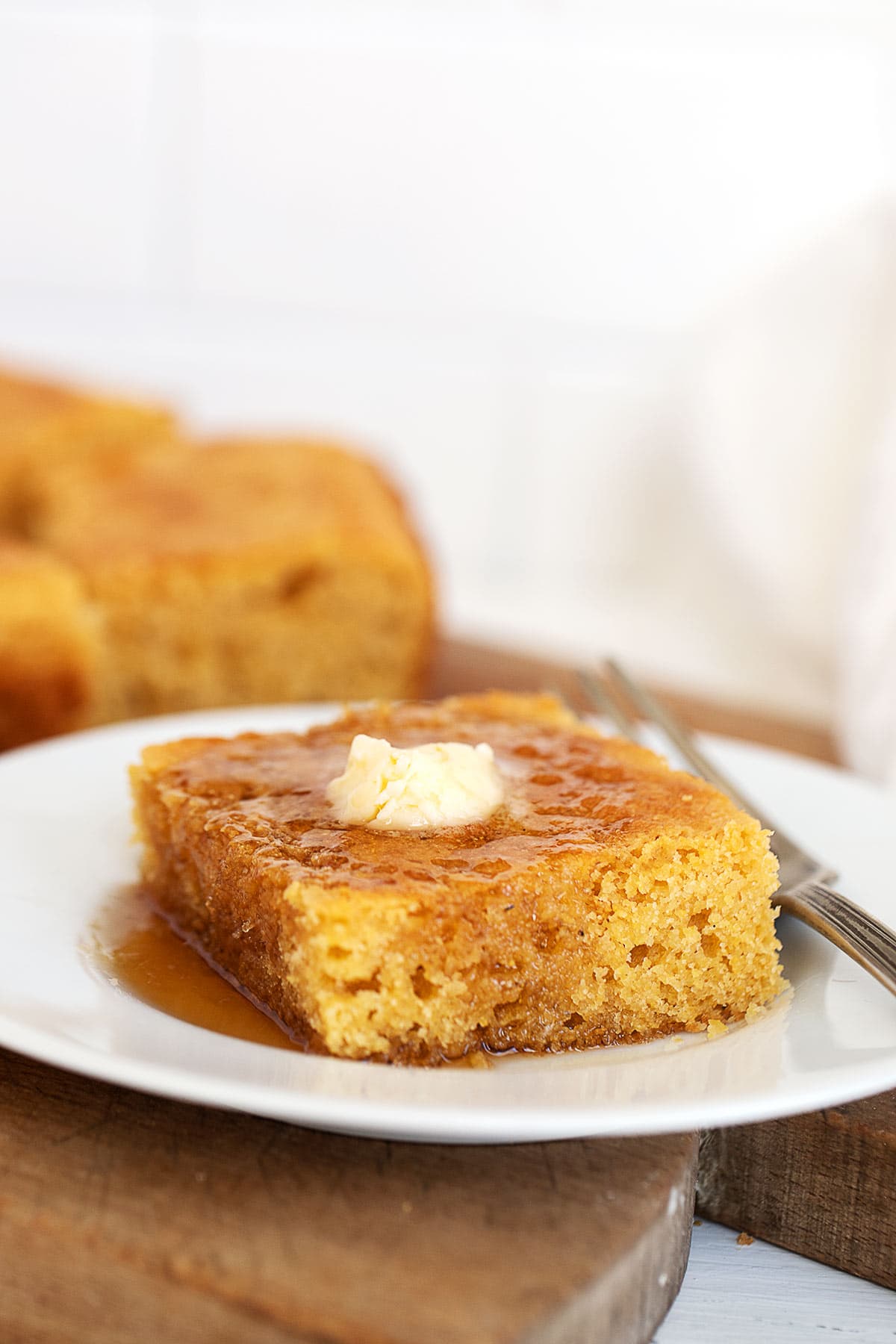  johnny cake with maple syrup and butter on plate