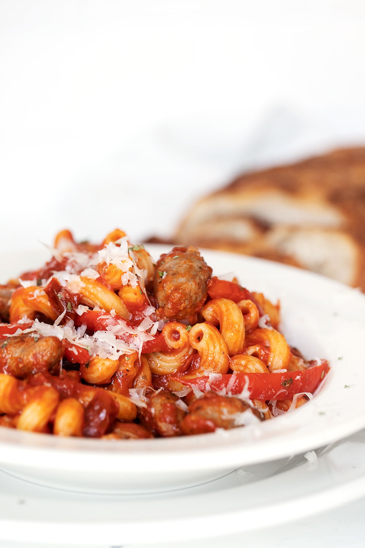 sausage and pepper pasta in white bowl