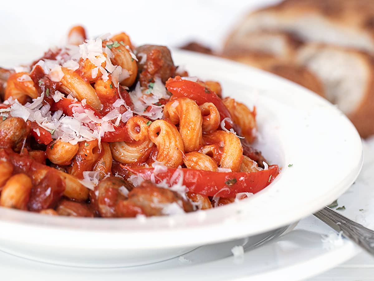 sausage and pepper pasta in white bowl