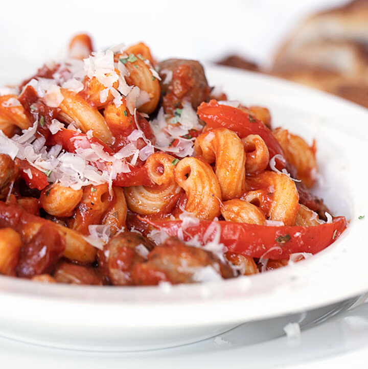 sausage and pepper pasta in white bowl