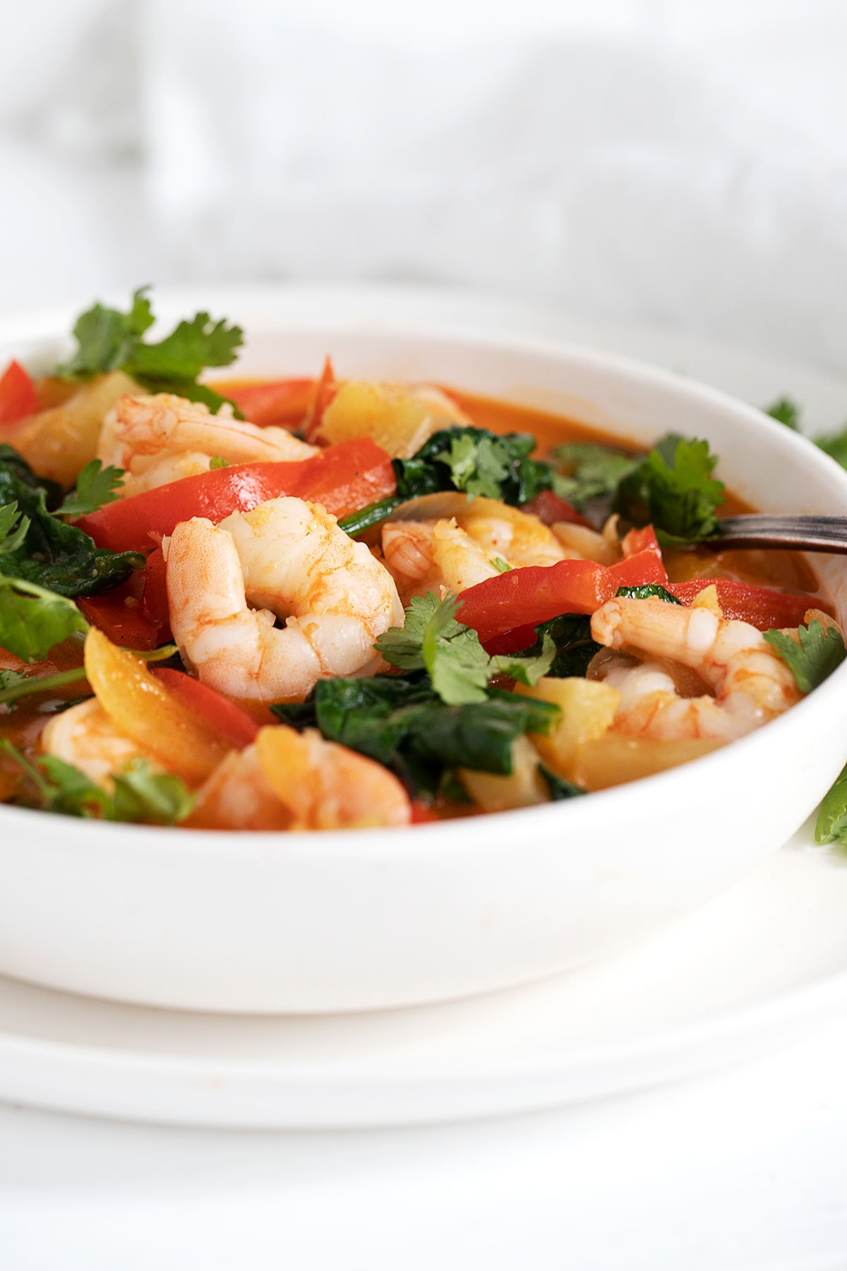 Thai red curry shrimp in white bowl