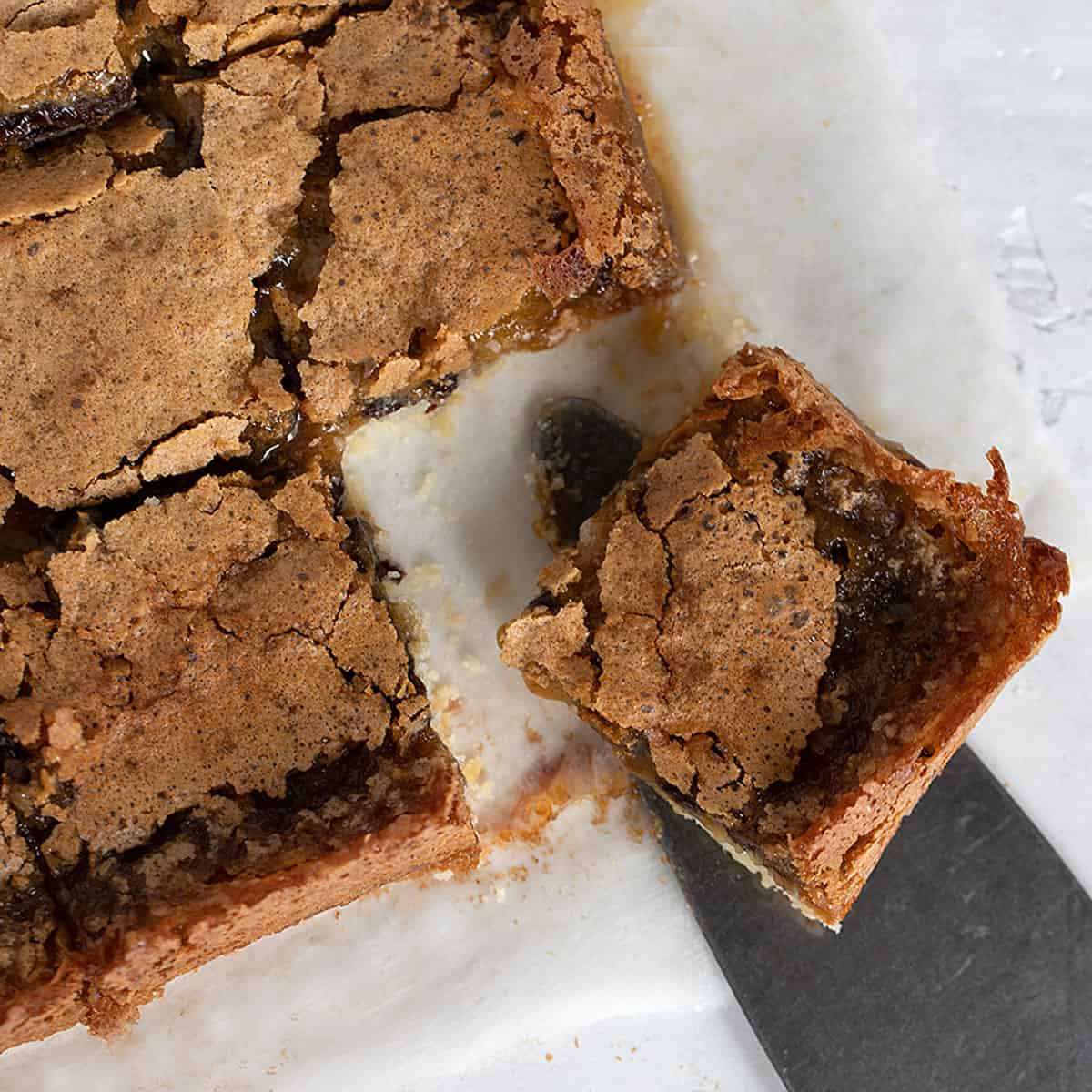 butter tart squares cut on parchment paper