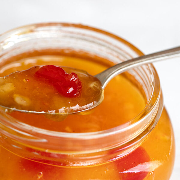 peach marmalade spooned from jar