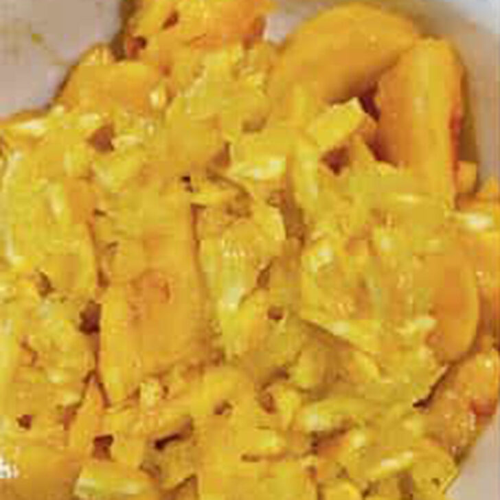 Prepared peaches and oranges in a bowl.