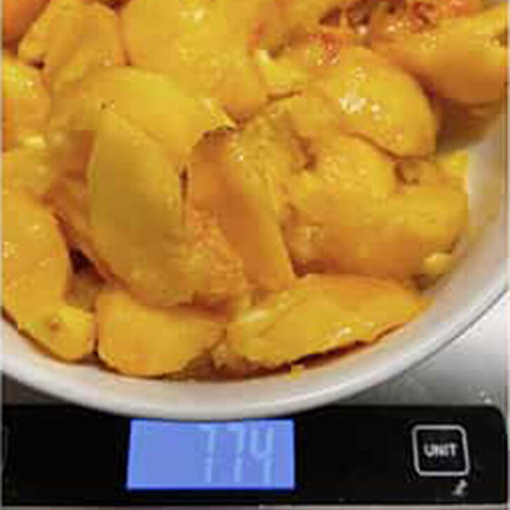 Weighing prepared peaches and oranges.