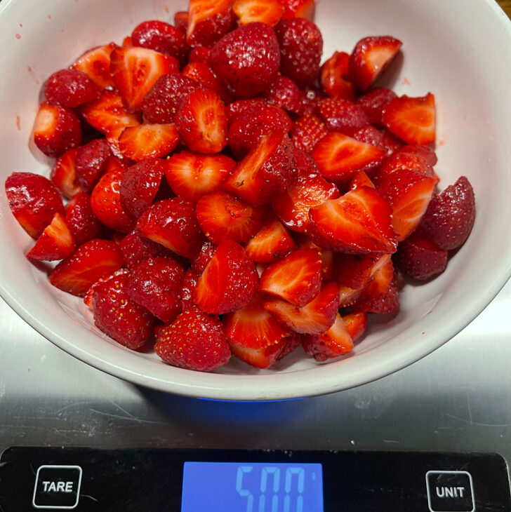 Weight the fresh strawberries on a scale.