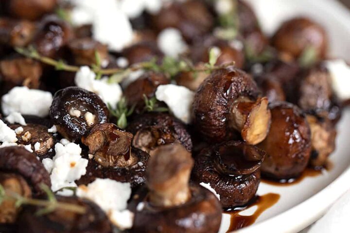 air fried mushrooms in bowl with balsamic and goat cheese