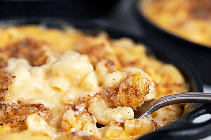 creamy mac and cheese in cast iron skillets with fork