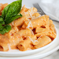 roasted red pepper pasta on plate with basil