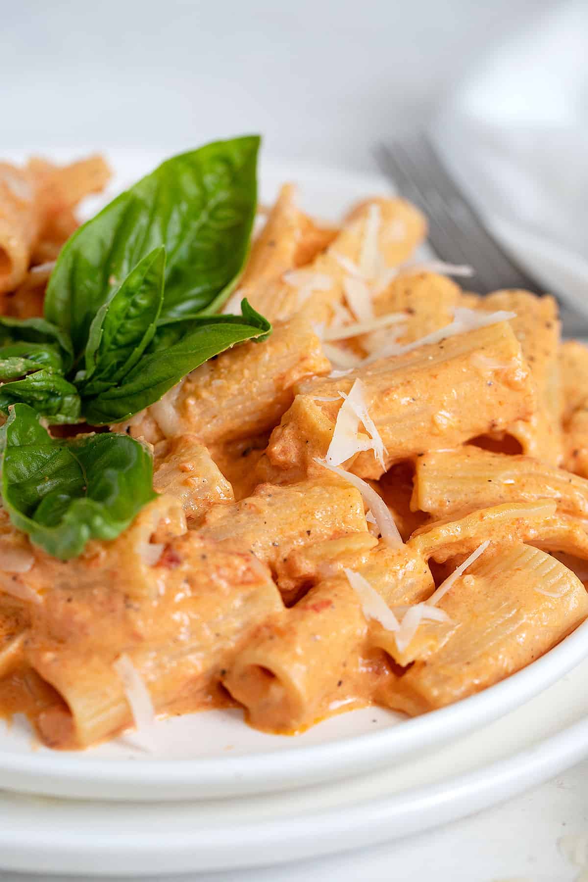 roasted red pepper pasta on plate with basil