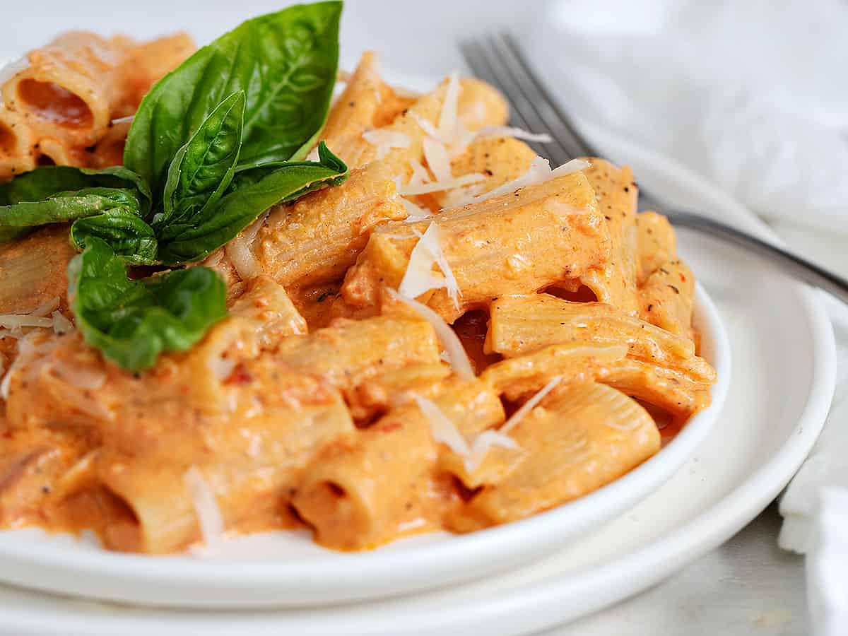 roasted red pepper pasta on plate with basil