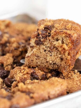 banana chocolate chip snack cake in pan with slice out