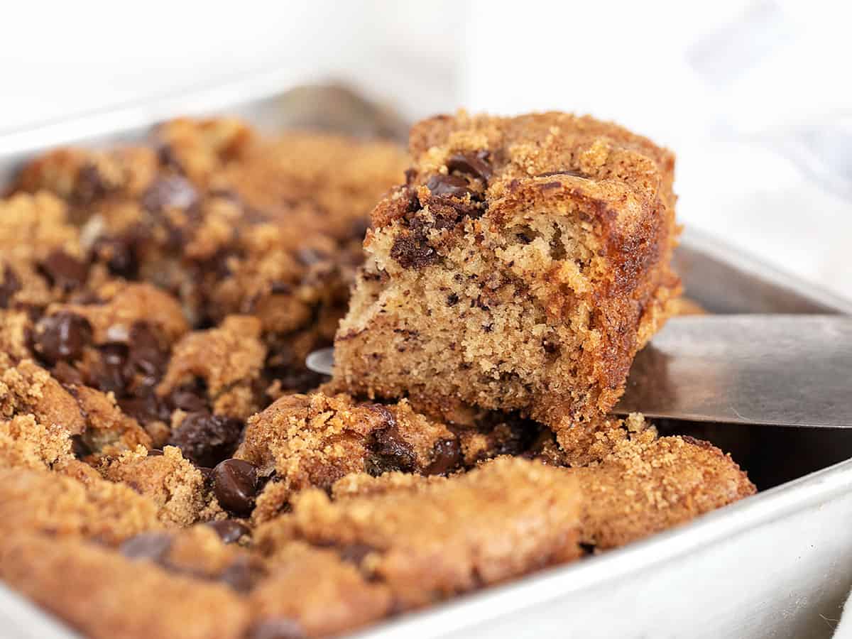banana chocolate chip snack cake in pan with slice out
