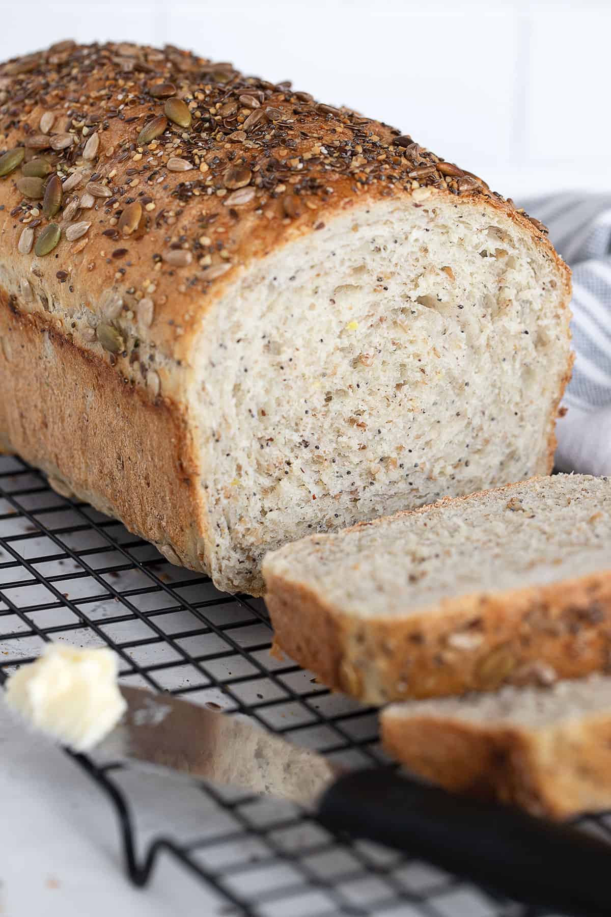 seeded multigrain bread sliced on cooling rack