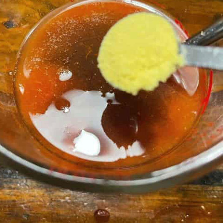 Adding mustard powder to the BBQ sauce.