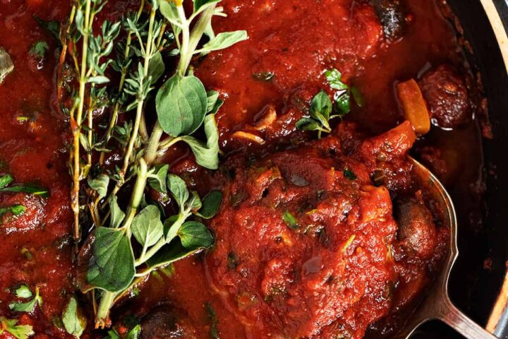 chicken cacciatore in pan with spoon